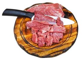 top view of cut raw meat on wooden board photo
