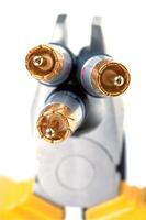 three gold plugs and pliers photo
