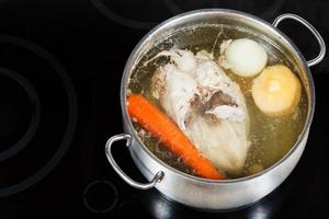 boiling of chicken broth on cermic cooker photo