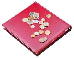 different coins on red numismatics album photo