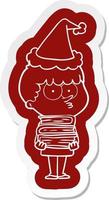 cartoon  sticker of a curious boy with lots of books wearing santa hat vector