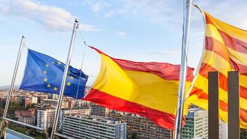 Catalan, Spanish, european flags over Barcelona photo