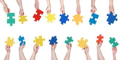 set different puzzle pieces in people hands photo