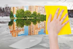 hand deletes ice block in river by yellow cloth photo