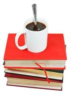 mug of coffee on stack of books photo