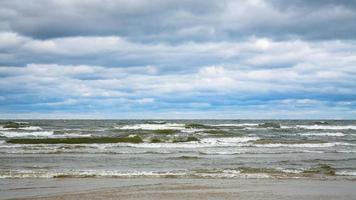low gray clouds over water of Baltic Sea photo