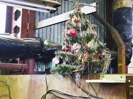 old decorated Christmas tree in workshop photo