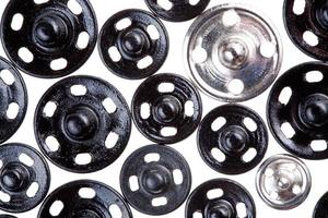 many different metal buttons isolated on white photo