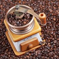 retro manual coffee mill on roasted beans photo