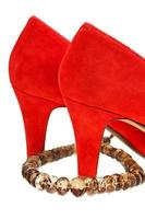 heelpieces of red high heel pumps with necklace photo