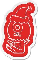 cartoon  sticker of a cyclops alien spaceman wearing santa hat vector