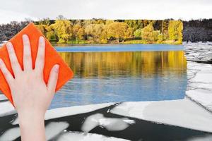 hand deletes ice floe in river by orange cloth photo