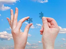 male and female hands with little puzzle pieces photo