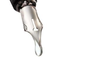 liquid drop dripping from nib of pen close up photo