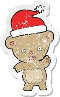 retro distressed sticker of a cartoon christmas teddy bear vector