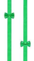 two little green bow knots on two parallel ribbons photo