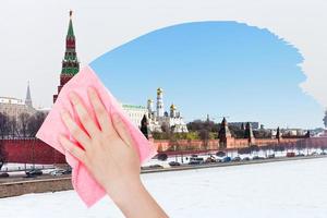 hand deletes winter view of Moscow by pink cloth photo