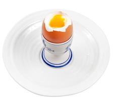 Light boiled egg in egg cup on white plate photo