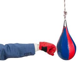 man in suit with boxing glove punches punching bag photo