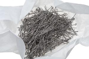 many steel tailor's pins in unwrap paper packet photo