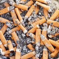 many cigarette butts close up photo