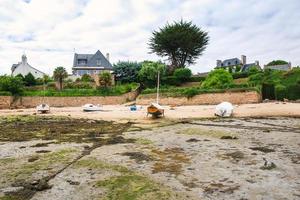 boats near country houses during low tide photo