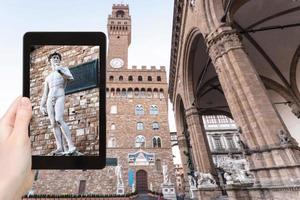 tourist photographs statue near palazzo vecchio photo