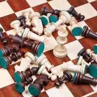 white king and scattered chess pieces photo