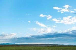 blue evening sky over winter crop fields in spring photo