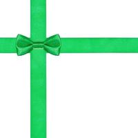 one green bow knot on two crossing satin ribbons photo