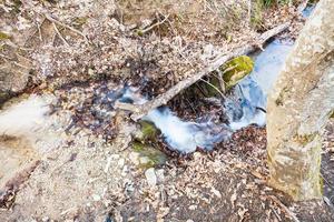 brook flows in caucasus mountain photo