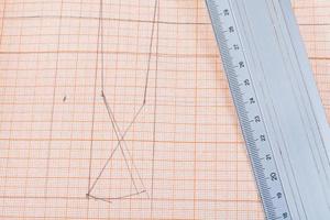 metal ruler at graph paper photo