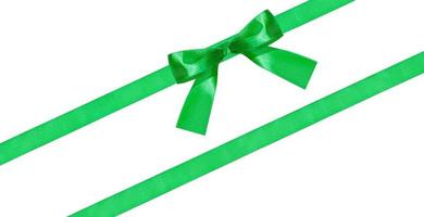 green bow knot on two diagonal silk bands isolated photo
