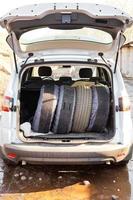 set of summer tires in boot of car photo