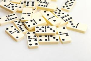 scattered dominoes on white close up photo