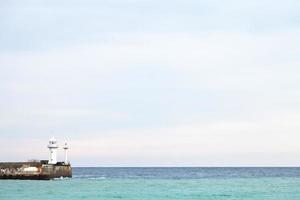 Black Sea and lighthouse in Yalta in autumn photo