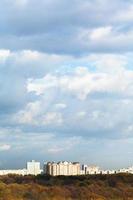 blue clouds over urban houses on horizon photo