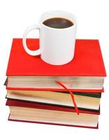 white mug of coffee on stack of books photo
