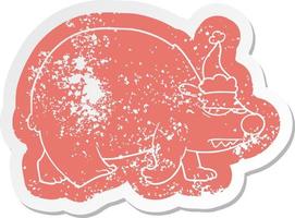 cartoon distressed sticker of a angry polar bear wearing santa hat vector