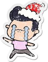 distressed sticker cartoon of a man crying wearing santa hat vector