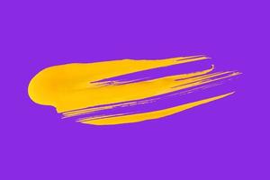 yellow brush isolated on purple background photo