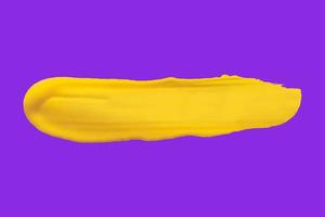 yellow brush isolated on purple background photo