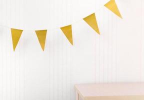 golden bunting flags over an empty table. mock up scene, stage for product presentation. copy space for design. showcase for home decor photo