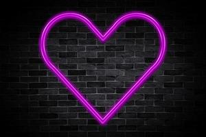 Heart symbol sign neon banner on brick wall background with copy space. photo