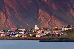 Sunset glowing on Icelandic village by coastline in Snaefellsnes Peninsula on summer at Iceland photo