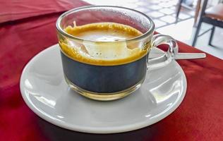 Glass Cup of black coffee in a restaurant Phuket Thailand. photo