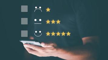 Male consumers use smartphones to assess their satisfaction and to rate and review online. Customer Experience Survey Concepts for Services and Products and Customer Engagement photo