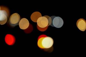 Abstract colorful bokeh reflection lighting on the road and black background. photo