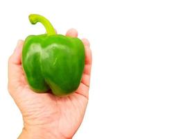 Hand of person holding a green bell pepper  isolate on white background and make with clipping paths. photo