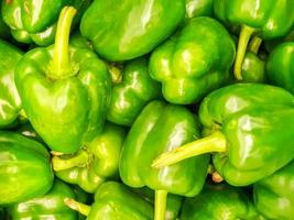 Closeup and crop heap of green bell pepper  fit on screen background and wallpaper. photo